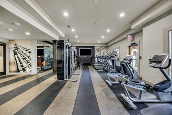 A gym with treadmills and elliptical machines.